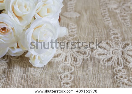Yellow flowers on beige lace fabric use for background