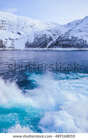 Beautiful pure clean blue water in mountains covered by snow. Scenery from Norway