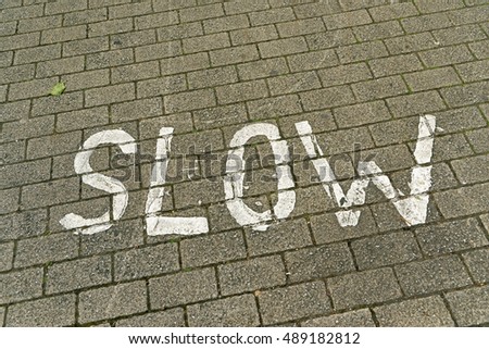 "SLOW" sign on the road