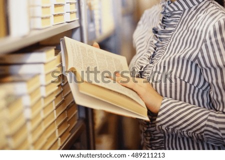 photo of Young woman reading a book