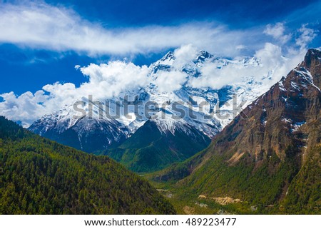 Landscape Snow Mountains Nature Viewpoint.Mountain Trekking Landscapes Background. Nobody photo.Asia Travel Horizontal picture. Sunlights White Clouds Blue Sky. Himalayas Rocks