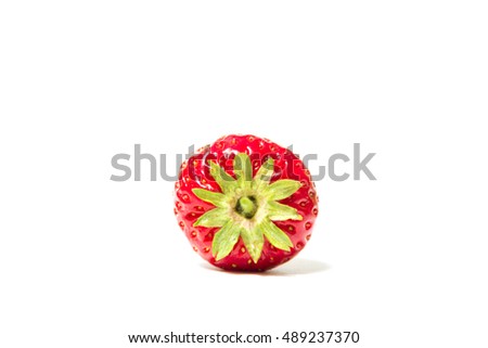 Red and ripe strawberry lies on its side on a white background - Isolate