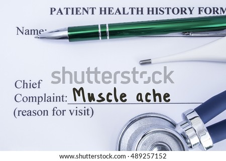 Complaint of muscle ache. Paper health history form, which is written on the patient's chief complaint of muscle ache, surrounded by a stethoscope, electronic thermometer and a green ball-point pen