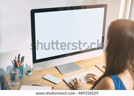 Mock-up of blank screen computer, Young girl graphic designer using modern computer while working at office, graphic designer working on new project, blurred background