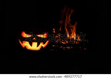 Halloween Scary Pumpkin fireplace with fire, isolated in the dark