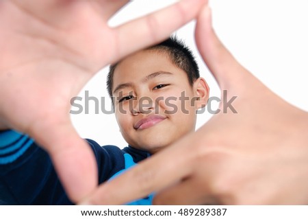 Young student boy making framing key gesture