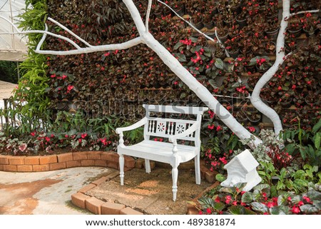 Wood lawn chair in a beautiful garden.