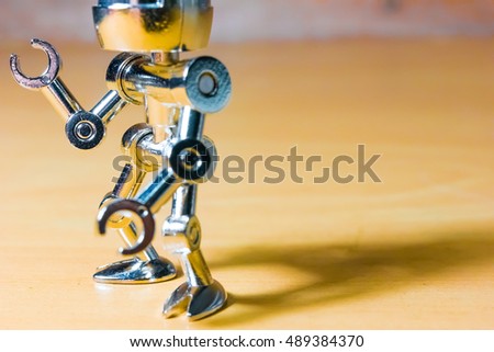 Robotic pointing arm on wooden background with the bank space for texting. - Vintage Tone.
