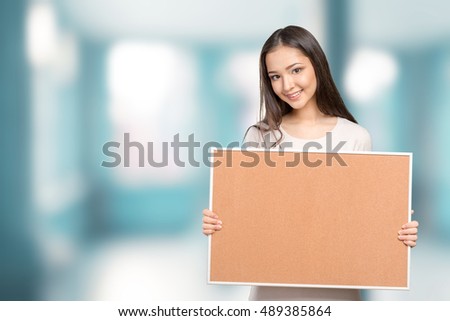 Young dark hair woman keeping cork board