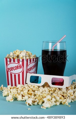 Bucket of popcorn against a blue background