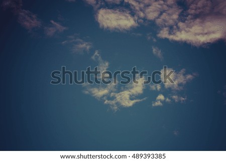 Blue sky with white cumulus clouds. Toned.