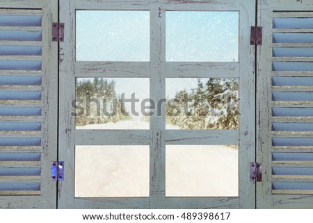 Old window sill in front of dreamy and magical winter snow  landscape background