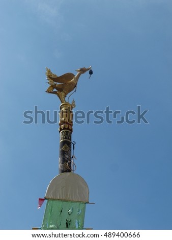 Golden swan statue in blue sky