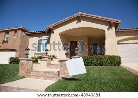 Blank Real Estate Sign in Front of Beautiful New Home.
