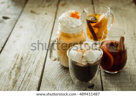 Selection of autumn drinks on wood background