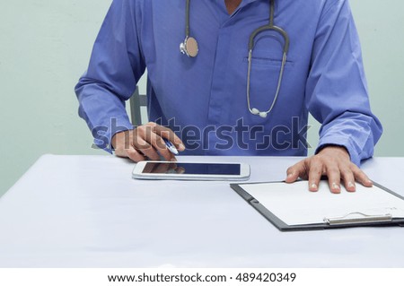 Doctor working with tablet at desk