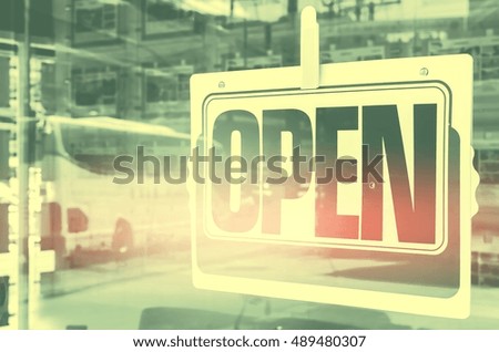 Open sign broad through the glass of door in cafe. Business and service concept. Retro tone filter color effect.