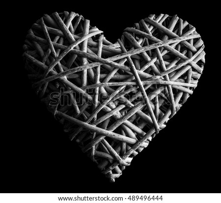 osier, sallow, vine braided on a frame in the form of hearts on a black background - pictures concept theme Love and St. Valentine's Day
