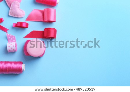 Tailor set of ribbons and threads on color background