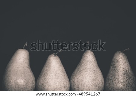 Close-up photo of pears isolated on black background.