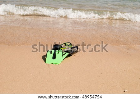 flippers and mask on a sand