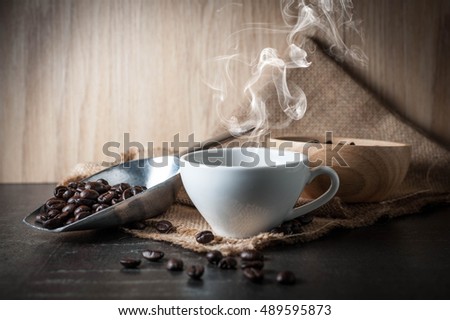 Coffee cup with coffee bean on black stone background