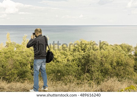 Beautiful sea landscape. A man photographs the sea and the sky. Selective focus.