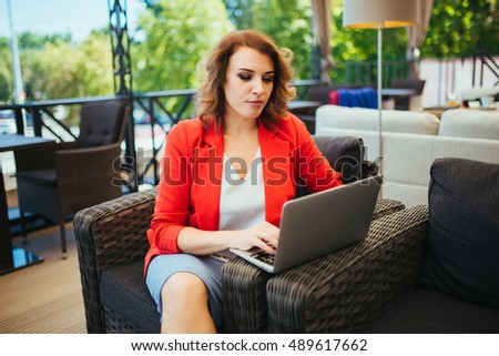 Successful businesswoman using laptop computer while sitting in lounge cafe. Thinking about new ideas during work on laptop computer.