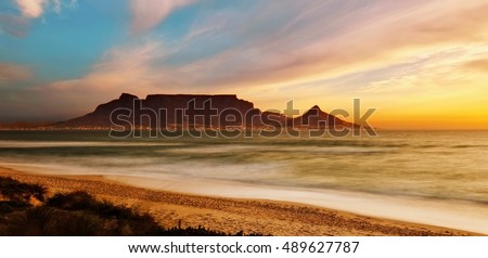 Table Mountain Panoramic Landscape with Beautiful Colorful Sunset and Streaking Clouds Landscape, Cape Town, South Africa Royalty-Free Stock Photo #489627787