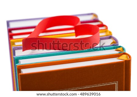 new books in colorful hard cover and bookmarks in the form of hearts isolated on white background - pictures concept theme Love and St. Valentine's Day