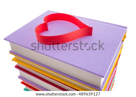 new books in colorful hard cover and paper tape in the shape of heart isolated on white background isolated on white background - pictures concept theme Love and St. Valentine's Day