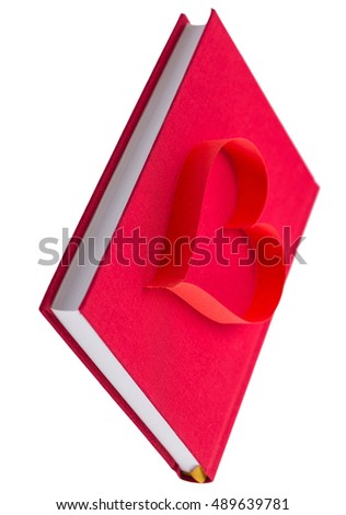 new book in red hard cover and paper tape in the shape of heart isolated on white background isolated on white background - pictures concept theme Love and St. Valentine's Day