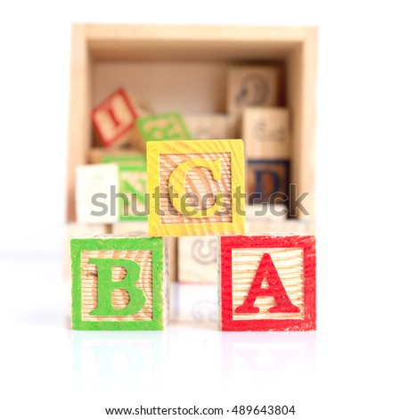 colorful wooden alphabet blocks, isolated on white.