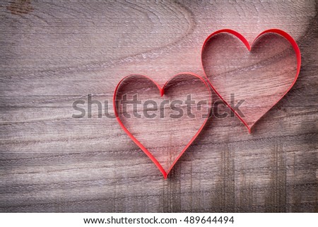 two beautiful romantic paper tape in the shape of heart on a vintage wooden background - pictures concept theme Love and St. Valentine's Day