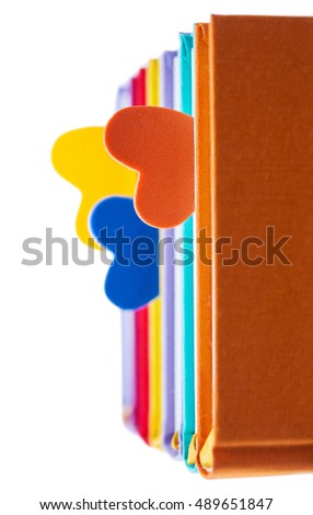 new books in colorful hard cover and bookmarks in the form of hearts isolated on white background - pictures concept theme Love and St. Valentine's Day