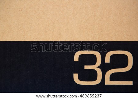 number thirty two with black stripe on grunge old brown paper texture