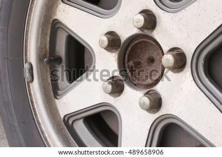 Close up old and rust car wheel with disc brake. Transportation concept photography.