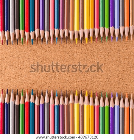 color pencils on cork background with copy space.