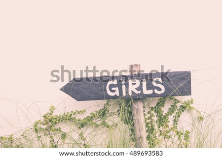 Girls sign on wooden black arrow pointing left vintage pastel tone