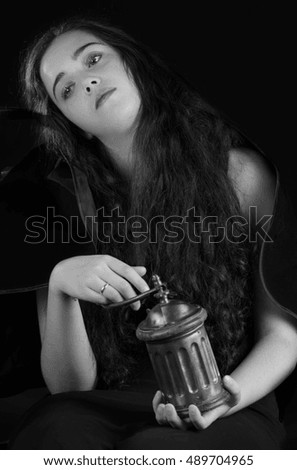 Young woman manipulating a coffee grinder