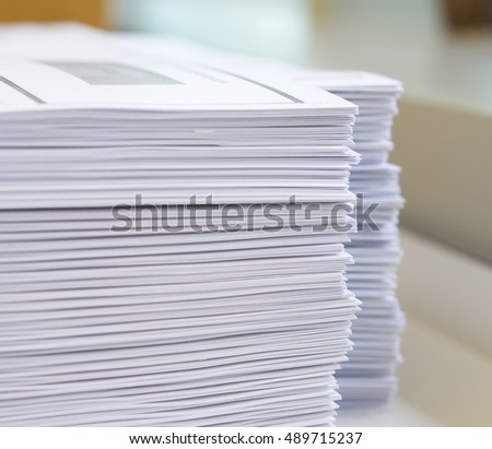 Stack of handout organized for conference on desk at office. Royalty-Free Stock Photo #489715237