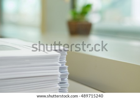 Stack of handout organized for conference on desk at office. Royalty-Free Stock Photo #489715240
