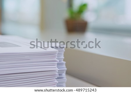 Stack of handout organized for conference on desk at office. Royalty-Free Stock Photo #489715243