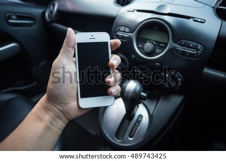 Hand use smart phone while driving car.