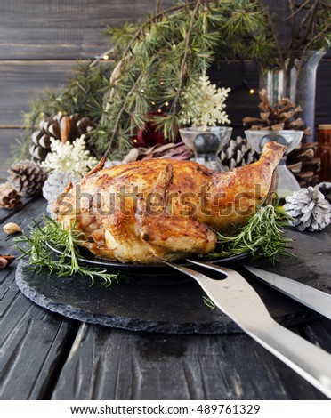 Roast chicken for Christmas and New Year with mulled wine and Christmas decorations, selective focus