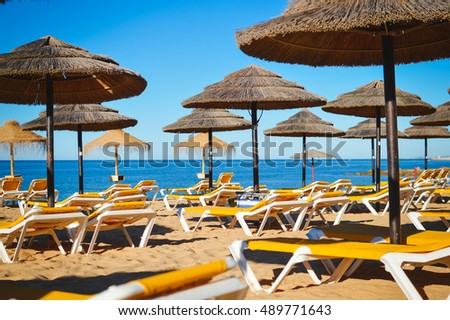 Beach ready for tourists. Golden sand with blue water and sky outdoors nature background