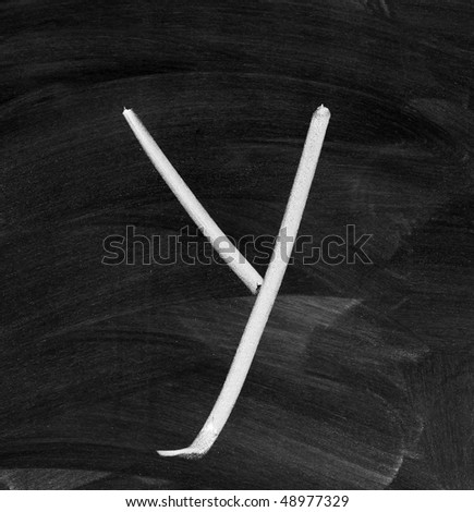 The letter "Y" written with white chalk on a blackboard gray