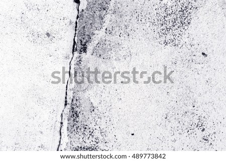 Crack in the concrete pavement as abstract background, texture of white painted cement flooring