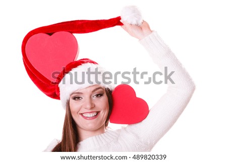 Helping giving and love concept. Happy smiling woman in santa hat holding red heart box present. Christmas winter time.