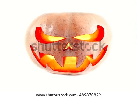 very scary Halloween pumpkin on a white isolated background with a glow inside